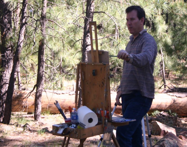 photograph of the artist Kevin McCain painting in the woods near the Mogollon Rim in Arizona.