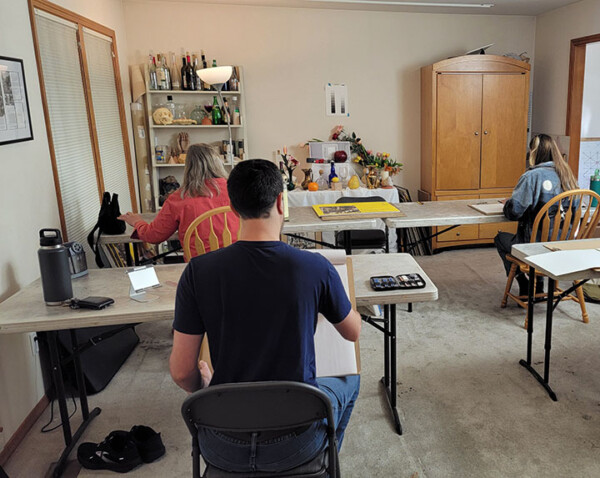 photo of students in classroom drawing.